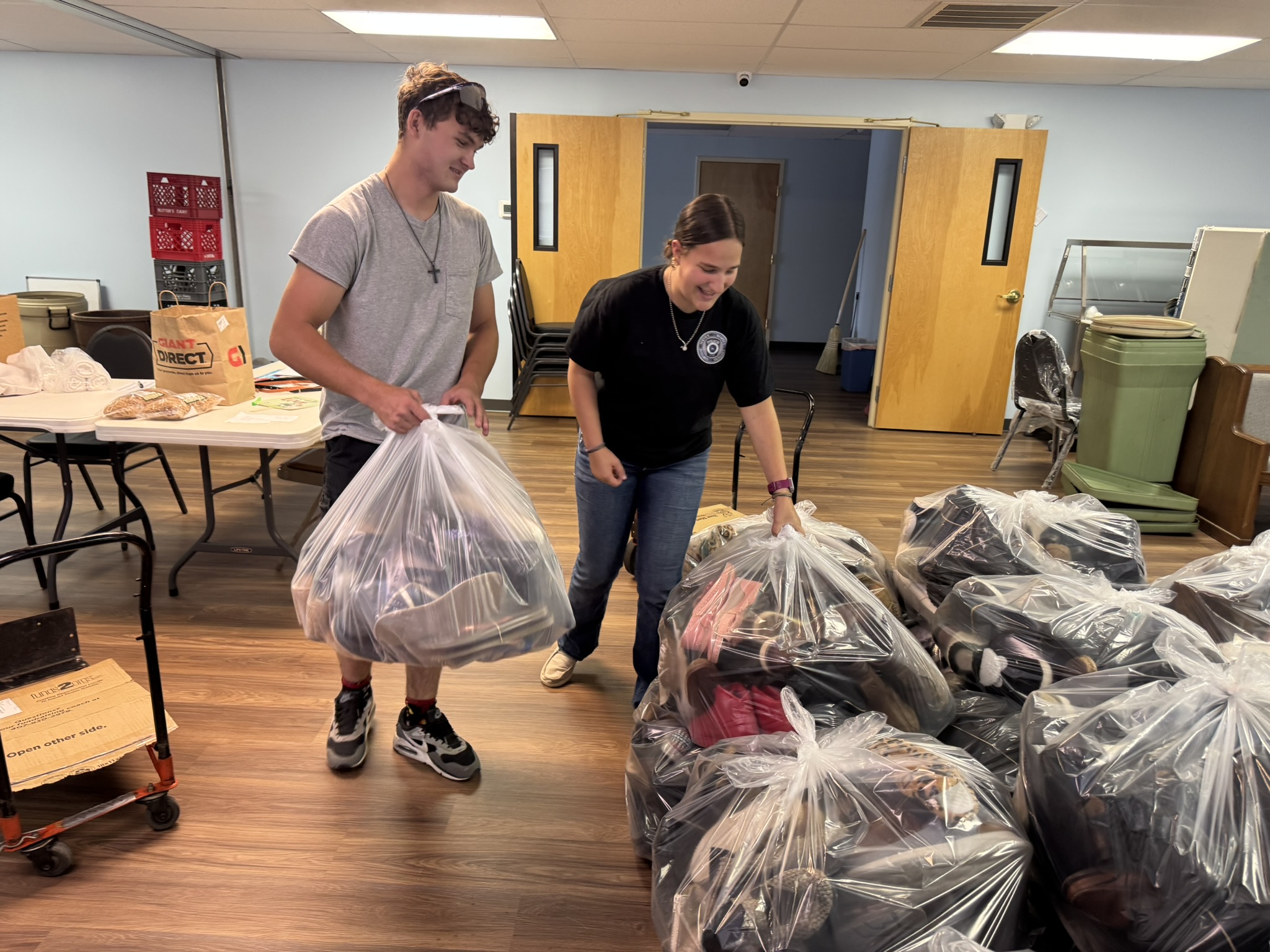 Jordan and Sophia helping with donated shoes